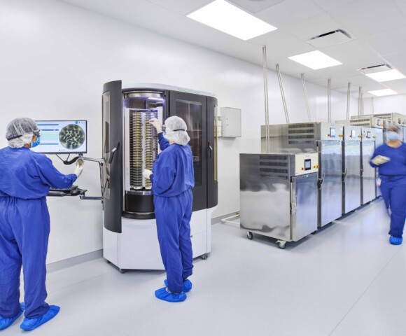 Two people using a pharmaceutical machine